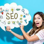 Woman holding a thought bubble sign that says SEO surrounded by colourful graphics.